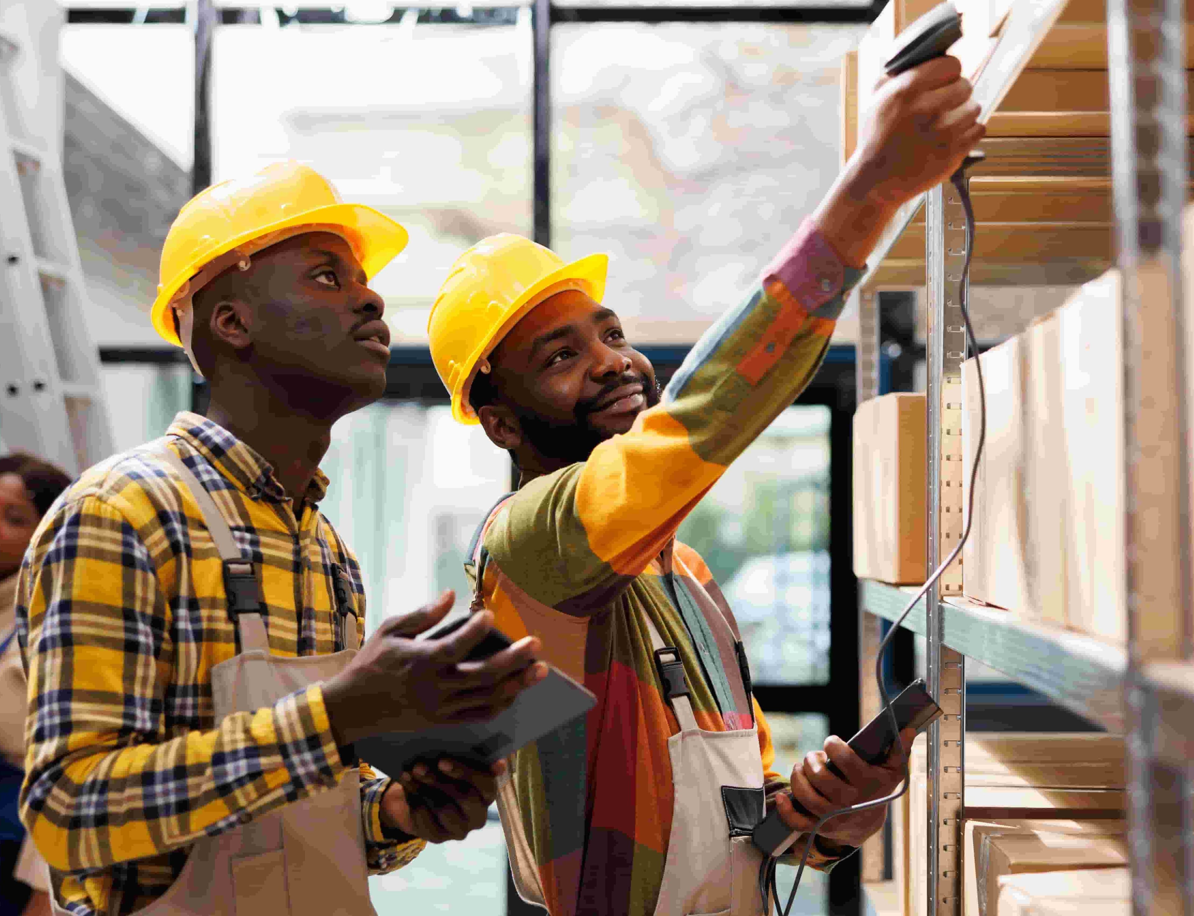 Two construction workers on yellow helmets